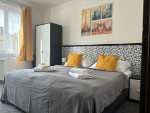 a bedroom with a large bed with towels on it at Hotel Pangea in Telč