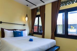 Giường trong phòng chung tại Sabina Boutique Hotel & Villa Mui Ne