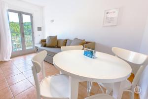 a living room with a white table and a couch at The Desmais in Cala Galdana