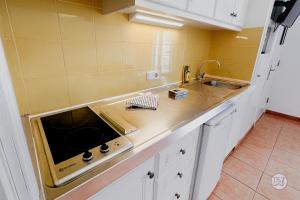 a kitchen with a sink and a counter top at The Desmais in Cala Galdana