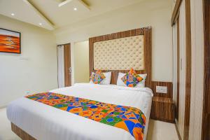 a bedroom with a large bed in a room at FabHotel Darshan Adobe - Nr Bus stand in Coimbatore