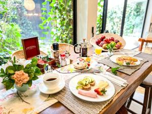 una mesa de madera con platos de comida y una taza de café en Lucitania Hotel Boutique, en Bogotá