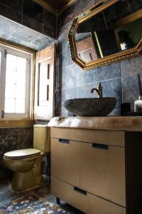 La salle de bains est pourvue d'un lavabo, de toilettes et d'un miroir. dans l'établissement Unique Luxurious 17-Century Smart Chapel in Center, à Sintra