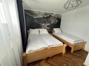 Vuode tai vuoteita majoituspaikassa Apartamenty u Mocarnego