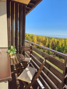 - un balcon avec deux chaises et une table avec vue dans l'établissement Tatranka - Vysoké Tatry, à Vysoké Tatry