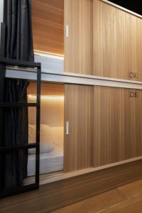 a room with wooden cabinets and a bunk bed at Hostal Siesta & Go Nuevos Ministerios in Madrid