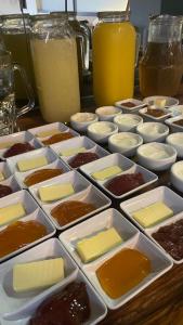 a table topped with trays of different types of desserts at Costalago Suites Hotel in Villa Carlos Paz