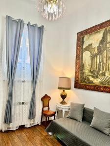 a living room with a couch and a chandelier at Colosseo Room in Rome