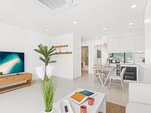 a white living room with a white couch and a table at The Hills Residence in Simpson Bay