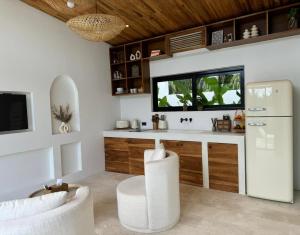 a kitchen with a counter with a sink and a refrigerator at Tropical Pool Villa near Fishermans Village in Bophut 