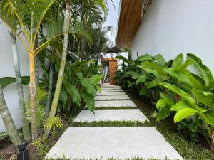 a garden path with palm trees and plants at Tropical Pool Villa near Fishermans Village in Bophut 