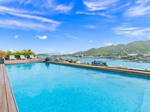 a swimming pool with a view of the water at The Hills Residence in Simpson Bay