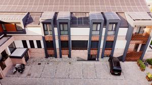 an aerial view of a building with solar panels on it at No Pardon Hotel in Satu Mare