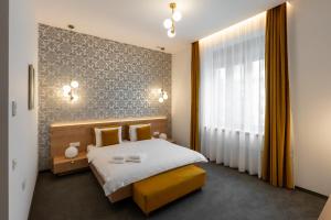 a bedroom with a bed and a large window at No Pardon Hotel in Satu Mare