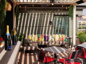 a patio with couches and a table and chairs at Sofitel Brussels Europe in Brussels