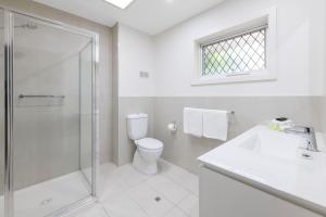 a bathroom with a shower and a toilet and a sink at Elizabethan Lodge in Melbourne