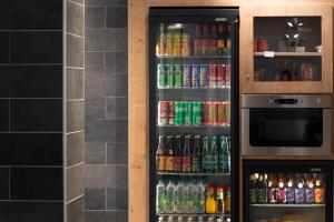 a refrigerator filled with lots of sodas and drinks at Campanile Metz Nord - Talange in Talange