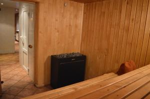 a corner of a room with a wooden wall at Guesthouse & sauna by HMTL in Liepāja