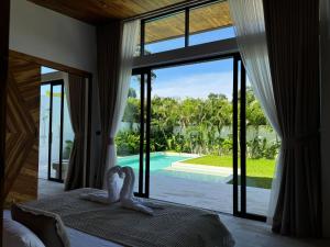 a bedroom with a bed and a view of a pool at Tropical Pool Villa near Fishermans Village in Bophut 