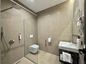 a bathroom with a shower and a toilet and a sink at Hotel PANORAMA Kruje view on the castle and the old town in Krujë