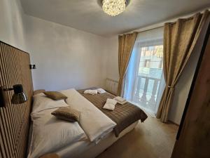 Кровать или кровати в номере Apartmán pod Tatrami K 107