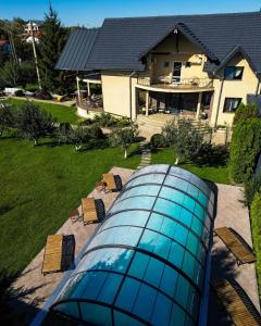 una casa con piscina di fronte a una casa di Orchard Villa a Braşov