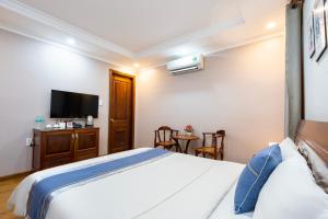 A bed or beds in a room at CAMY Hotel Vung Tau