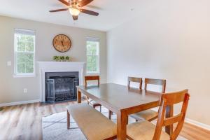 een eetkamer met een tafel en stoelen en een klok bij Glen Burnie Vacation Rental with Private Deck! in Glen Burnie