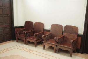 a group of three chairs sitting in a room at Villa KiengKham晶康民宿 in Luang Prabang