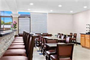 a dining room with tables and chairs in a restaurant at SureStay Plus by Best Western Windsor in Windsor