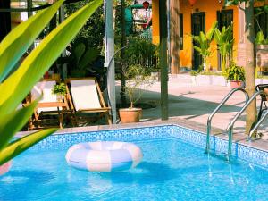 a swimming pool with a beach ball in the water at An Nam Ơi House Homestay in Tam Coc in Vũ Lâm