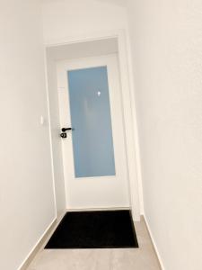 埃施伯恩Zweizimmerwohnung in wenigen Minuten in Frankfurt的一间房间里带黑色门垫的白色门