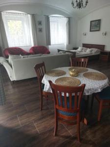 sala de estar con mesa, sillas y sofá en Dvůr U kapličky, en Žďár nad Sázavou