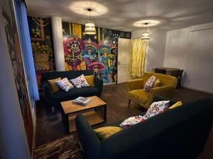 a living room with two couches and a table at Casa Talavera Hostel in Mexico City