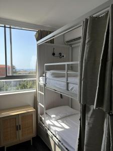 Letto a castello in camera con finestra di Little Coogee Hotel a Sydney