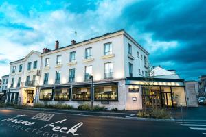 een groot wit gebouw aan de straatkant bij Hotel d'Angleterre in Châlons-en-Champagne