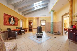 a living room with yellow walls and a lobby at Hotel Brunnenhof in Bayerisch Eisenstein