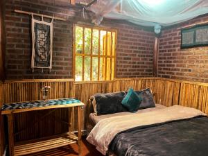 a bedroom with a bed and a window in it at Sapa's soul hillside in Sa Pa