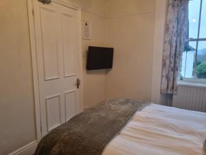 A bed or beds in a room at Montfort Cottage Guest House