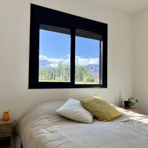 En eller flere senge i et værelse på Lo de Nieves - Casas con hermosa vista al Nevado y gran ubicación