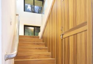 a wooden door leading up to a staircase with wooden floors at Thomson Imperial Boutique G0A in Calangute