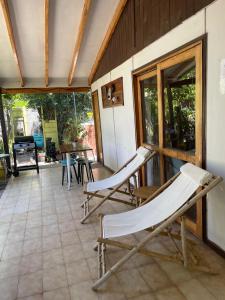 a porch with two chairs and a table on a house at Casa Doris in Vicuña