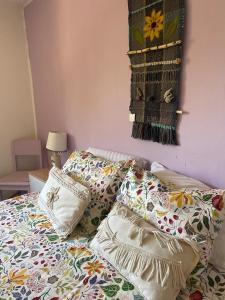 a bed with sheets and pillows on top of it at Casa Doris in Vicuña