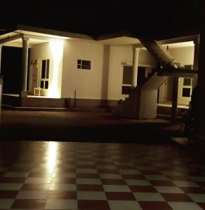 a house at night with a checkered floor at Malnad Bliss in Sringeri