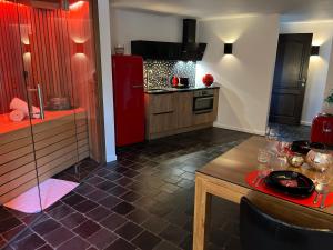 a kitchen with a red refrigerator and a table at OCV Infiny in Durbuy