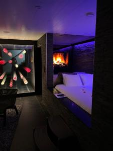 a bedroom with a bed and a fire in a room at OCV Infiny in Durbuy