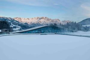 vista su un edificio con montagne sullo sfondo di Hotel Krallerhof a Leogang