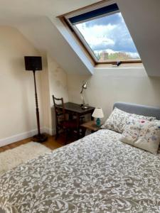 A bed or beds in a room at Damson Cottage