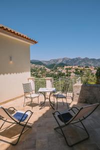 a group of chairs and a table on a patio at Palazzo Pascal in Scala