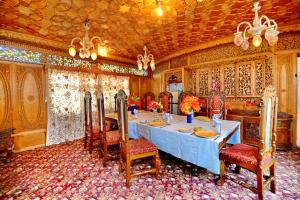 une salle à manger avec une table bleue et des chaises dans l'établissement Heritage Amina Group Of Houseboats, à Srinagar